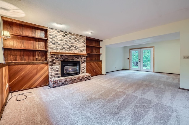 11476 65th Pl N, Maple Grove, MN 55369 - unfurnished living room with carpet flooring, a fireplace, french doors, and baseboards