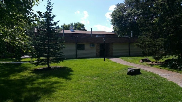 back of property with a lawn