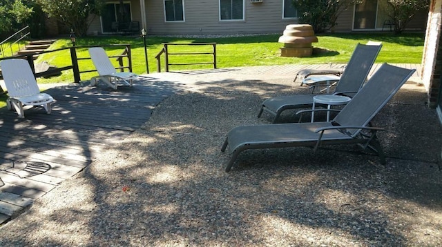 surrounding community with a wooden deck and a yard