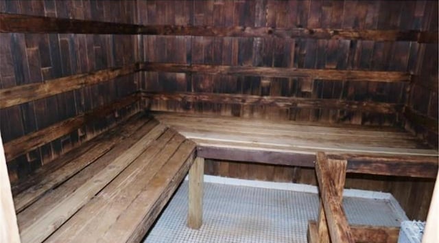 sauna featuring wooden walls