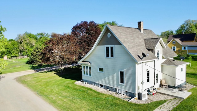 308 Cedar Ave S, Odessa, MN 56276 - view of side of property with a chimney, ac unit, and a lawn