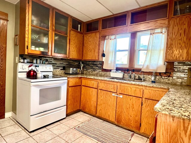 308 Cedar Ave S, Odessa, MN 56276 - kitchen featuring white electric range oven, tasteful backsplash, a sink, and light tile patterned floors