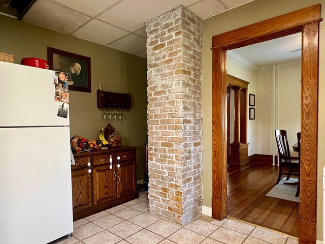 308 Cedar Ave S, Odessa, MN 56276 - hallway with ornate columns, a drop ceiling, light tile patterned flooring, and baseboards