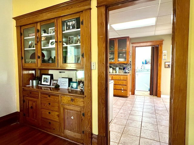 308 Cedar Ave S, Odessa, MN 56276 - bar featuring washer / clothes dryer and light tile patterned floors