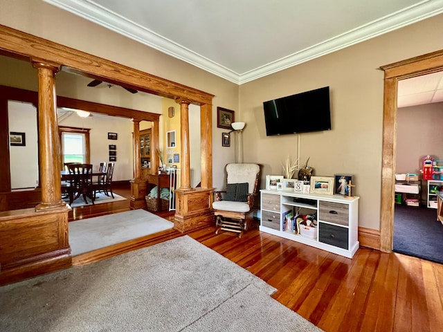 308 Cedar Ave S, Odessa, MN 56276 - living room with decorative columns, hardwood / wood-style flooring, crown molding, and baseboards
