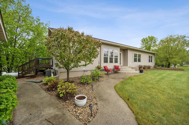 15350 Blackhawk Rd, Audubon, MN 56511 - view of front facade with a front lawn, a patio area, central air condition unit, stairs, and crawl space