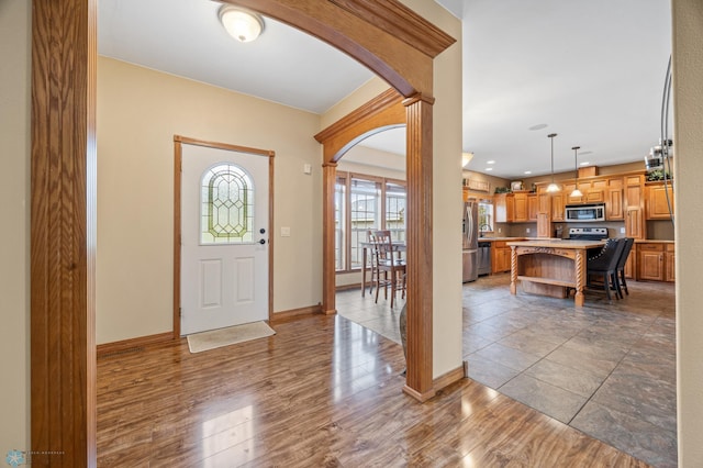 15350 Blackhawk Rd, Audubon, MN 56511 - foyer featuring arched walkways, baseboards, and wood finished floors