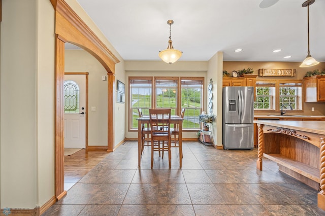 15350 Blackhawk Rd, Audubon, MN 56511 - dining space with baseboards, arched walkways, recessed lighting, and dark stone finish floors