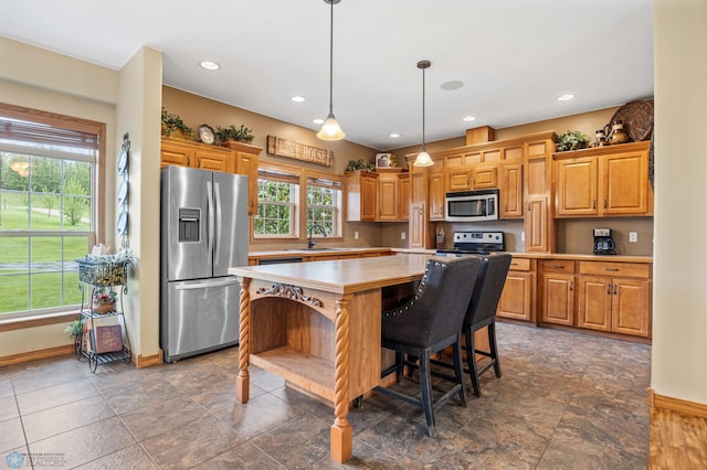 15350 Blackhawk Rd, Audubon, MN 56511 - kitchen featuring stainless steel appliances, baseboards, light countertops, a kitchen island, and hanging light fixtures