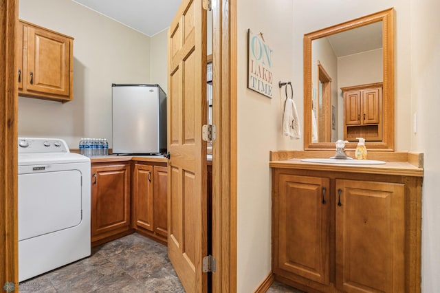 15350 Blackhawk Rd, Audubon, MN 56511 - laundry area with washer / dryer, cabinet space, and dark stone finish flooring
