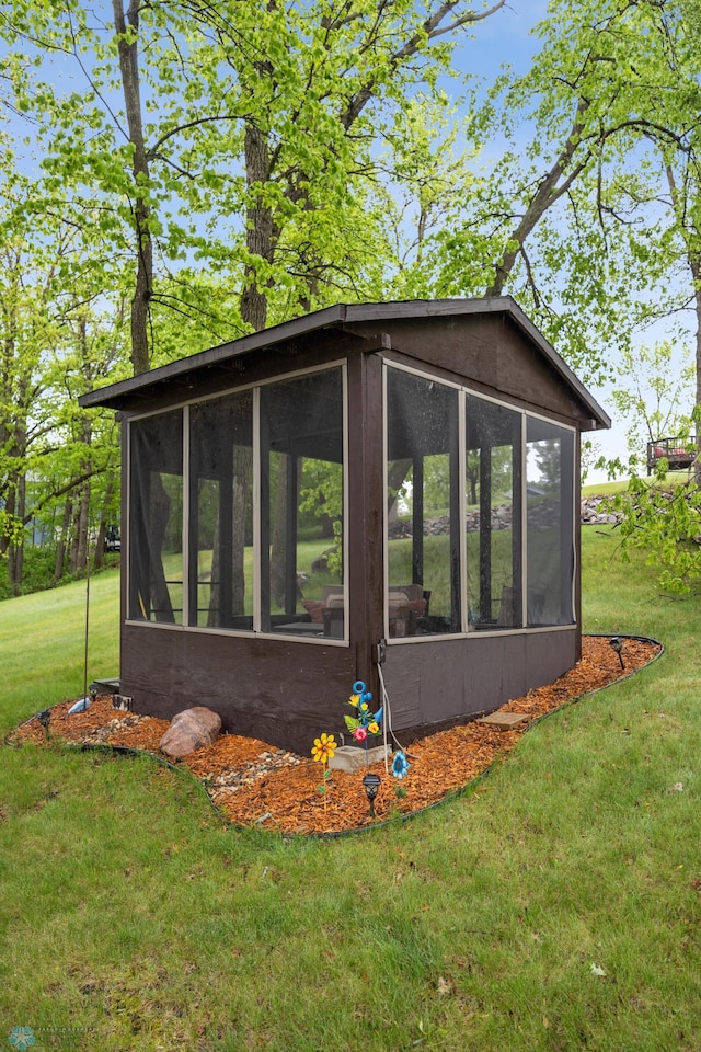 15350 Blackhawk Rd, Audubon, MN 56511 - view of side of property featuring a sunroom and a yard