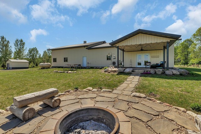 13936 County Road 7 NW, Clearwater Twp, MN 55320 - rear view of house with a fire pit, french doors, and a lawn