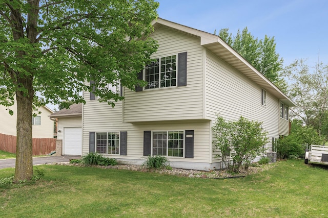 809 Orchard St, Belle Plaine, MN 56011 - view of front facade with driveway, an attached garage, and central air condition unit