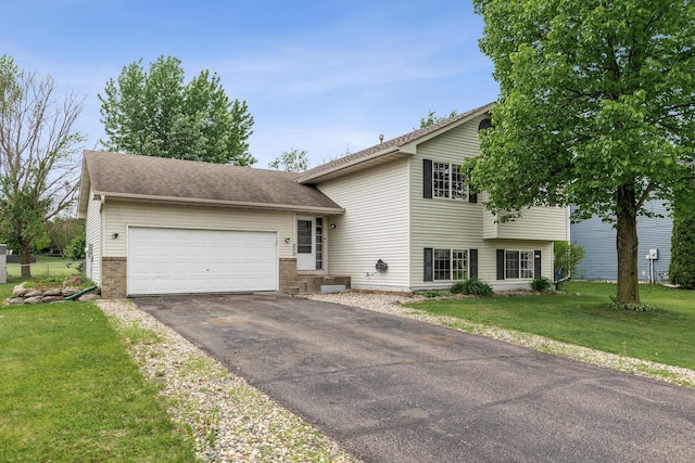 809 Orchard St, Belle Plaine, MN 56011 - split level home featuring asphalt driveway, an attached garage, a front yard, and brick siding