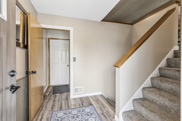 809 Orchard St, Belle Plaine, MN 56011 - foyer with light wood finished floors, stairway, and baseboards