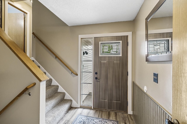 809 Orchard St, Belle Plaine, MN 56011 - entryway featuring wood finished floors and stairs