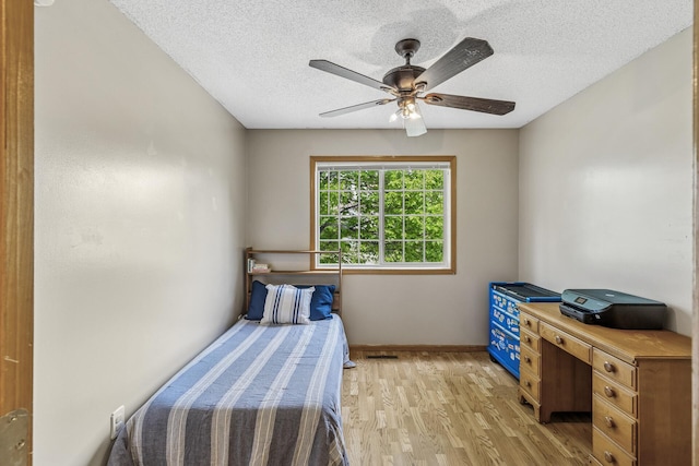 809 Orchard St, Belle Plaine, MN 56011 - bedroom with light wood-type flooring, a textured ceiling, baseboards, and ceiling fan
