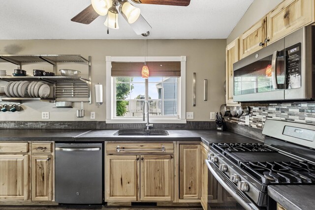 809 Orchard St, Belle Plaine, MN 56011 - kitchen with stainless steel appliances, a sink, dark countertops, and ceiling fan
