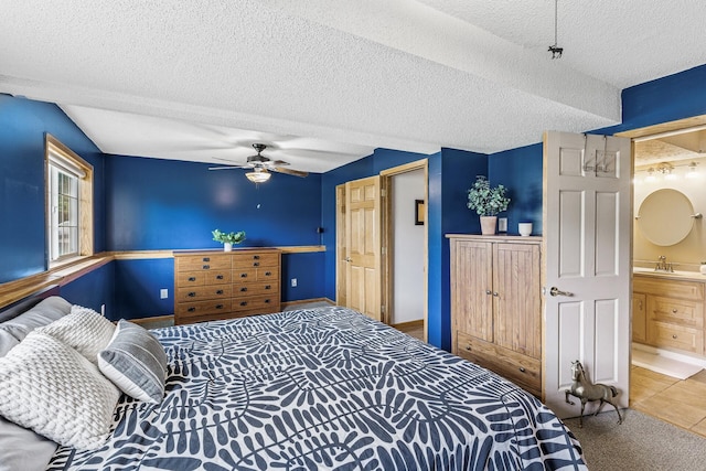 809 Orchard St, Belle Plaine, MN 56011 - bedroom with a sink, a textured ceiling, baseboards, ceiling fan, and ensuite bath