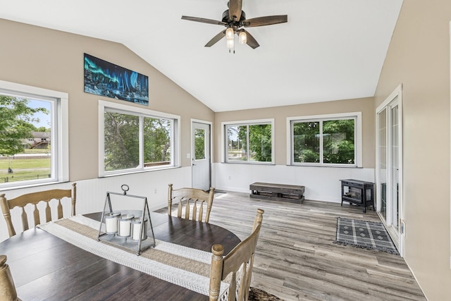 809 Orchard St, Belle Plaine, MN 56011 - dining room with lofted ceiling, wood finished floors, healthy amount of natural light, a ceiling fan, and a wood stove