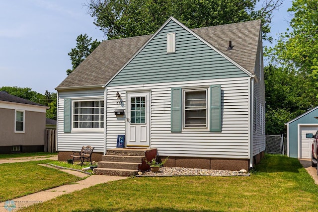 1538 10th St N, Fargo, ND 58102 - view of front facade with entry steps, a front lawn, and roof with shingles