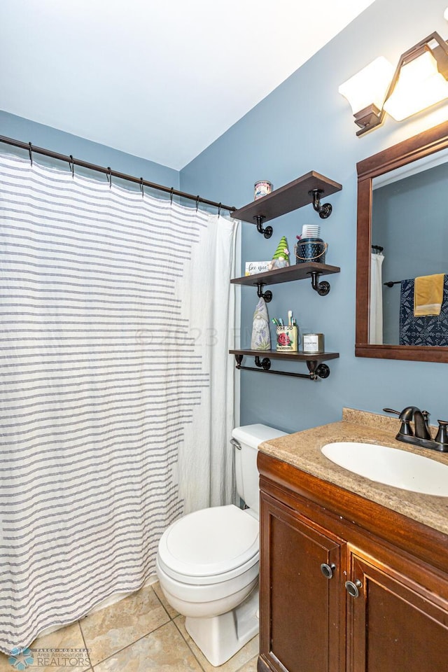 1538 10th St N, Fargo, ND 58102 - bathroom with toilet, vanity, and tile patterned flooring
