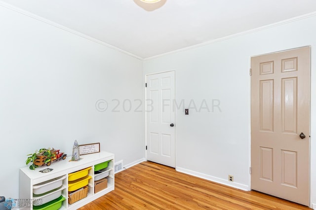 1538 10th St N, Fargo, ND 58102 - playroom featuring crown molding, light wood-type flooring, and baseboards