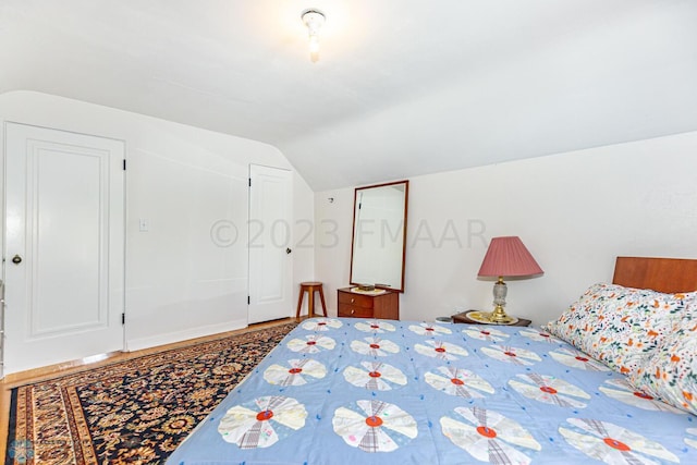 1538 10th St N, Fargo, ND 58102 - bedroom with lofted ceiling and wood finished floors