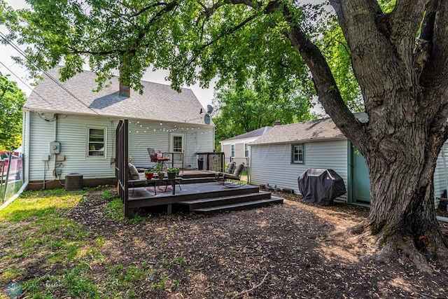 1538 10th St N, Fargo, ND 58102 - back of property with a wooden deck, fence, and a chimney