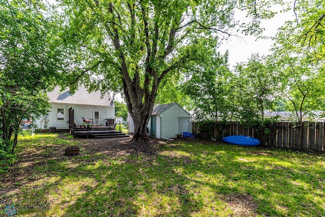 1538 10th St N, Fargo, ND 58102 - view of yard featuring a deck, an outdoor structure, and a storage unit