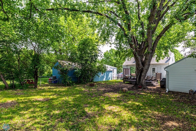 1538 10th St N, Fargo, ND 58102 - view of yard featuring a deck, an outdoor structure, and a shed