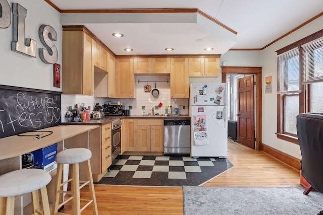 3205 Grand Ave S, Minneapolis, MN 55408 - kitchen with appliances with stainless steel finishes, ornamental molding, a sink, baseboards, and decorative backsplash