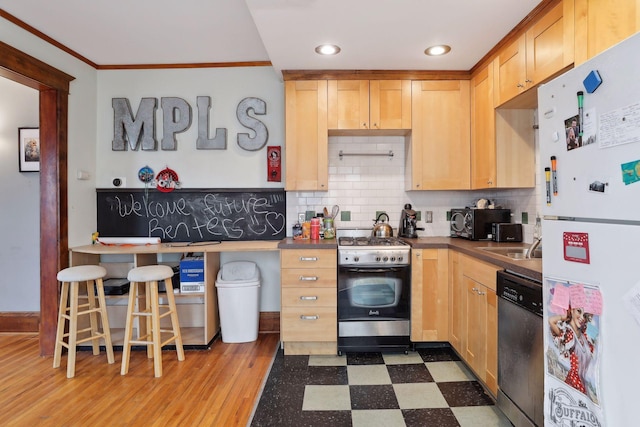 3205 Grand Ave S, Minneapolis, MN 55408 - kitchen featuring appliances with stainless steel finishes, ornamental molding, tile patterned floors, tasteful backsplash, and light brown cabinetry