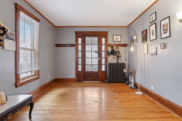 3205 Grand Ave S, Minneapolis, MN 55408 - doorway featuring radiator heating unit, ornamental molding, light wood finished floors, and baseboards
