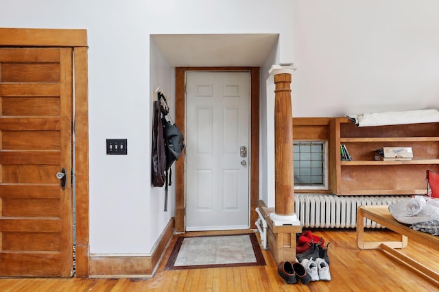 3205 Grand Ave S, Minneapolis, MN 55408 - entrance foyer with radiator, hardwood / wood-style floors, and ornate columns