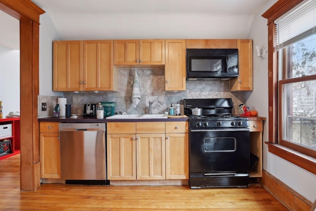 3205 Grand Ave S, Minneapolis, MN 55408 - kitchen featuring black appliances, light wood-type flooring, tasteful backsplash, and a sink