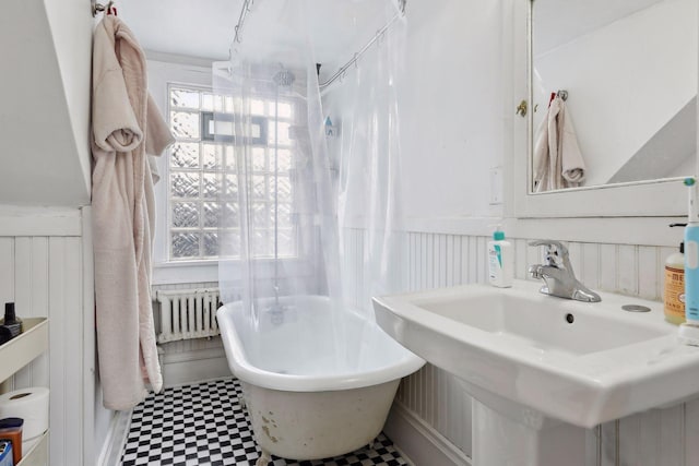3205 Grand Ave S, Minneapolis, MN 55408 - full bathroom featuring radiator, tile patterned floors, a freestanding tub, a wainscoted wall, and a shower