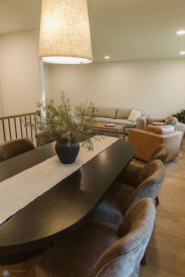 dining area with hardwood / wood-style flooring and recessed lighting