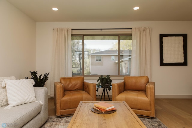 living area with wood finished floors, recessed lighting, and baseboards