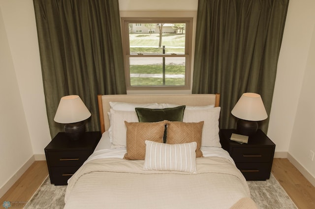 bedroom featuring baseboards and light wood-style floors