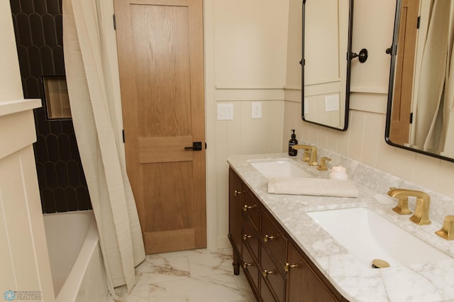 full bath with marble look tile flooring and double vanity