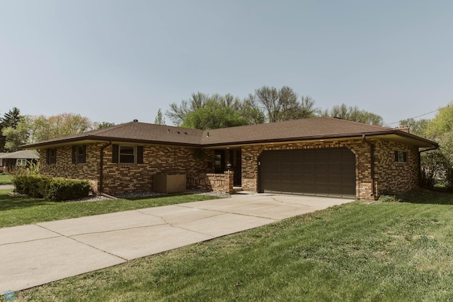 ranch-style house featuring a garage, concrete driveway, brick siding, and a front yard