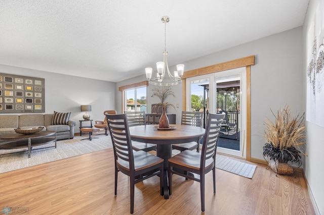 dining space featuring a chandelier and light wood-style flooring