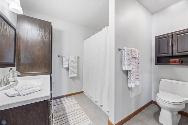 bathroom with toilet, tile patterned floors, vanity, baseboards, and curtained shower