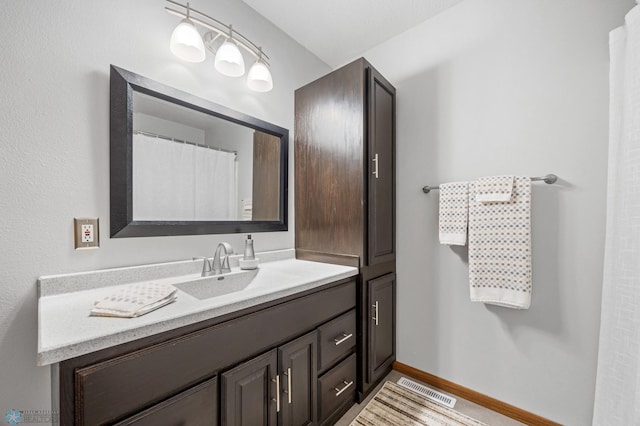 bathroom with vanity and baseboards