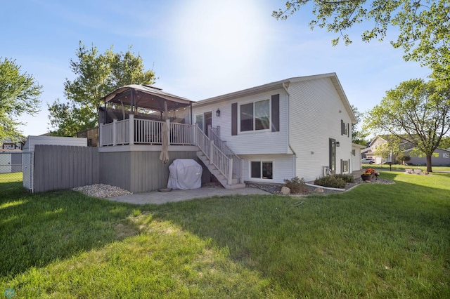 rear view of house featuring stairs and a wooden deck