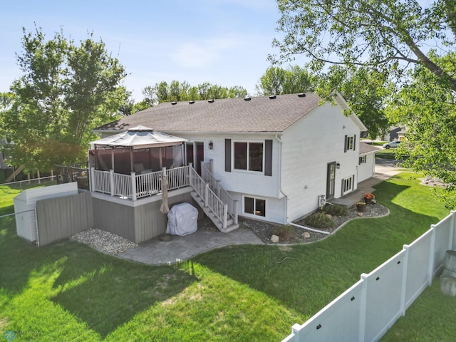 back of property featuring a gazebo, stairs, and a shingled roof