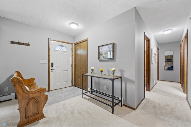 3105 Edgewood Dr N, Fargo, ND 58102 - foyer entrance featuring light colored carpet, a textured ceiling, a baseboard radiator, and baseboards