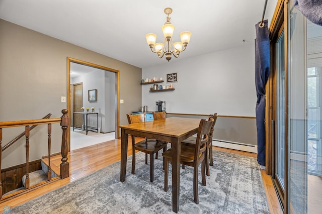 3105 Edgewood Dr N, Fargo, ND 58102 - dining space featuring baseboard heating, light wood-style flooring, a chandelier, and healthy amount of natural light