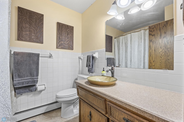 3105 Edgewood Dr N, Fargo, ND 58102 - full bath featuring baseboard heating, toilet, vanity, tile patterned floors, and a wainscoted wall